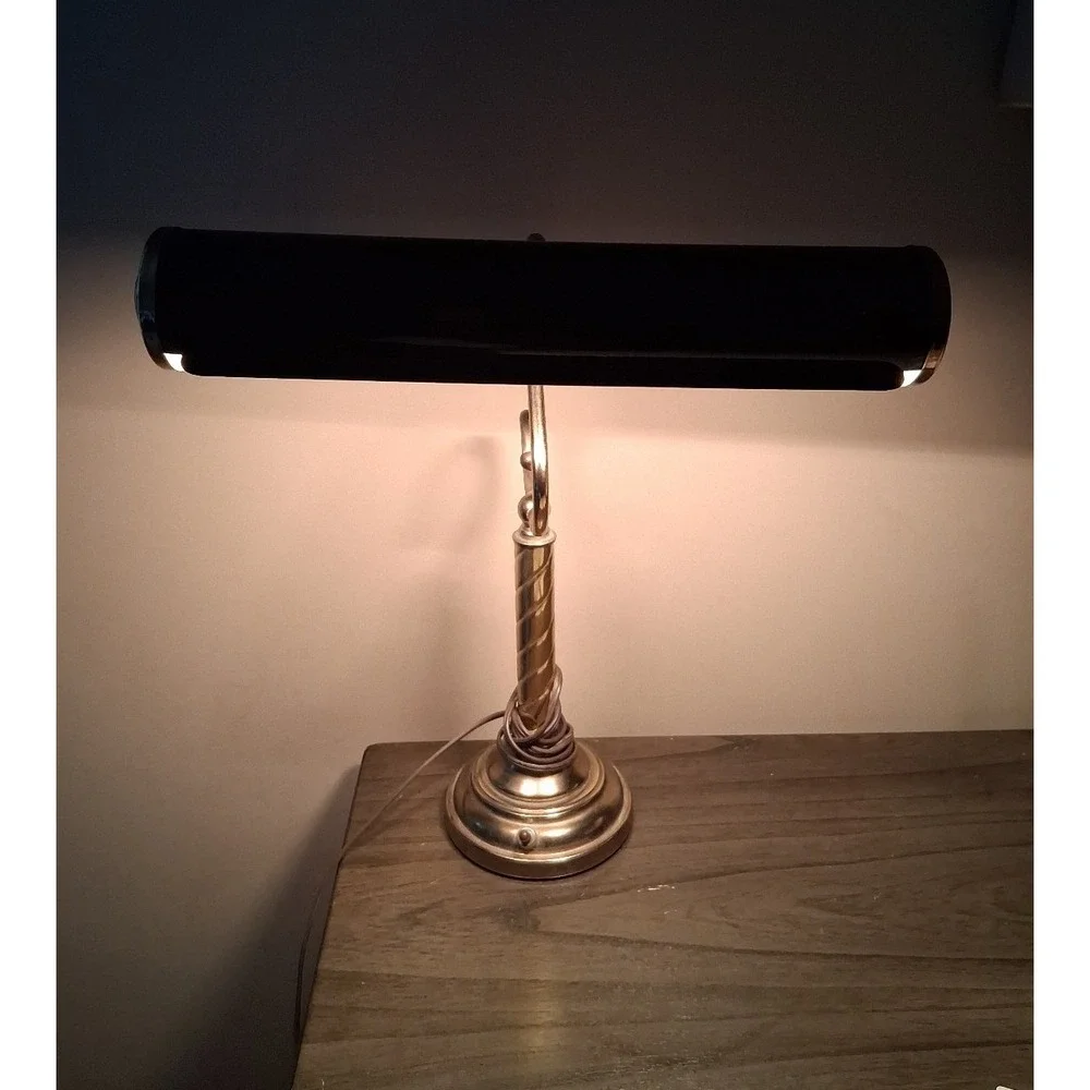 Vintage brass tone desk lamp with elegant scroll arm and classic piano light